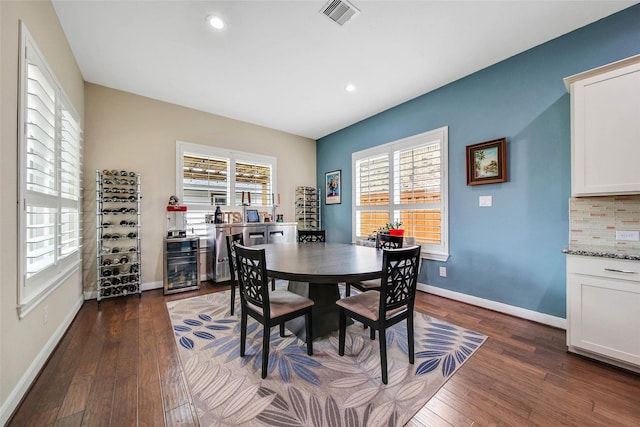 dining area with dark hardwood / wood-style flooring