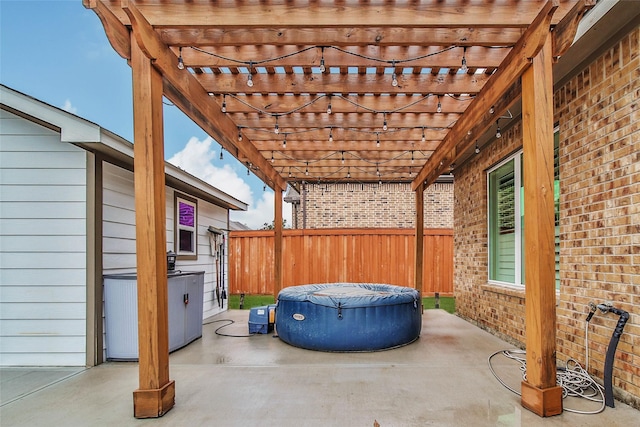 view of patio / terrace featuring a pergola and a hot tub