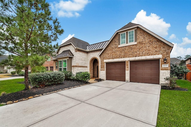 view of front of property featuring a garage and a front yard