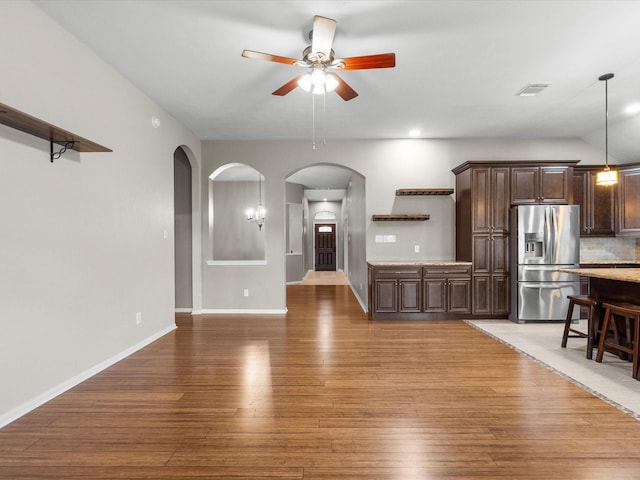 unfurnished living room with hardwood / wood-style flooring and ceiling fan