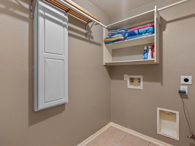 laundry room featuring electric dryer hookup, washer hookup, and light tile patterned floors