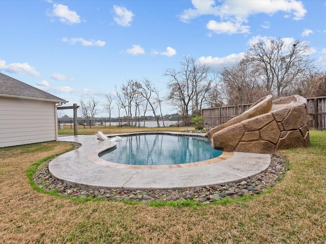 view of pool featuring a lawn and a diving board