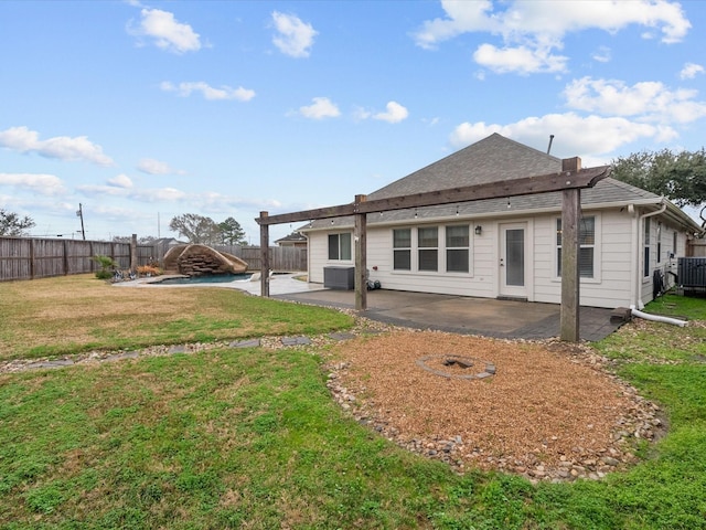 back of house featuring a patio and a lawn