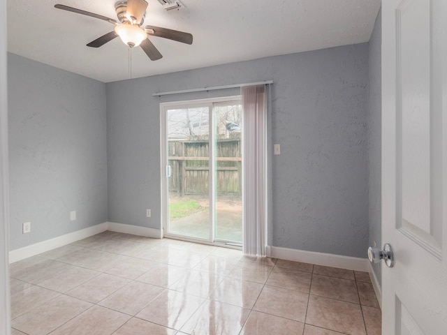 unfurnished room with ceiling fan and light tile patterned floors