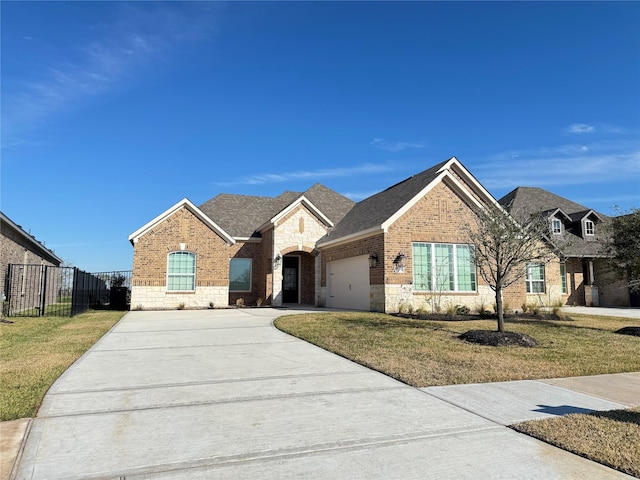 view of front of house with a garage and a front lawn