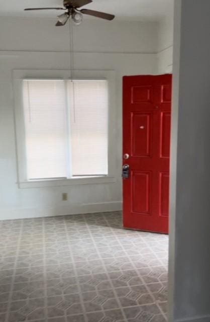 foyer entrance with ceiling fan