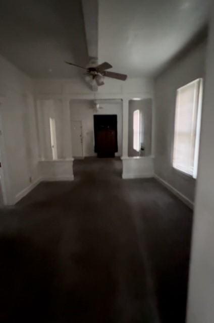 unfurnished living room with ceiling fan