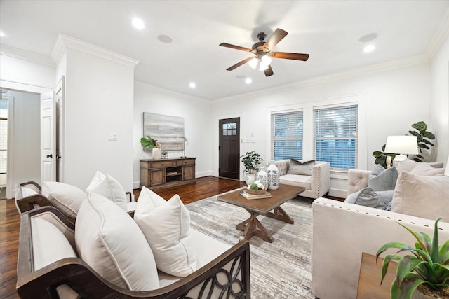 living room featuring crown molding, dark wood-type flooring, and plenty of natural light