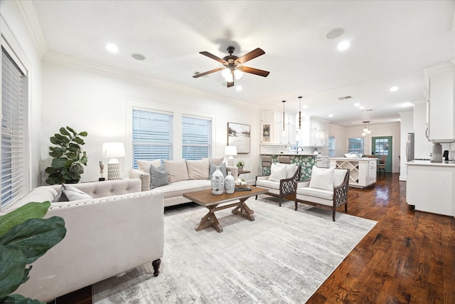 living room with crown molding, ceiling fan, and dark hardwood / wood-style flooring