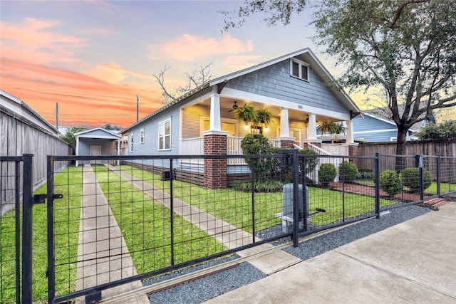 bungalow-style home featuring a lawn and covered porch