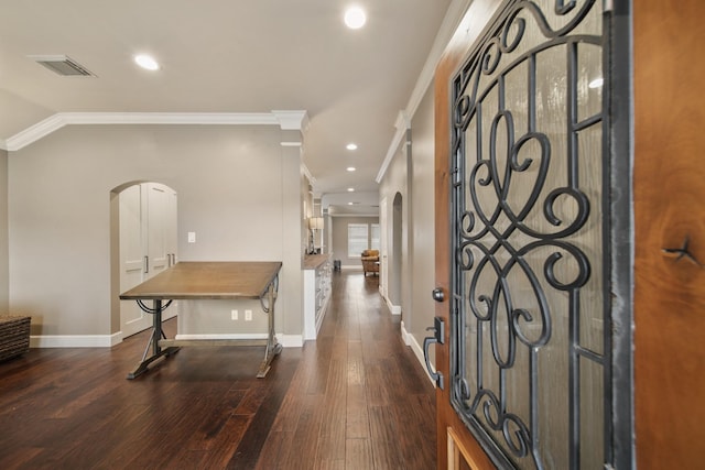 foyer with crown molding and dark hardwood / wood-style floors