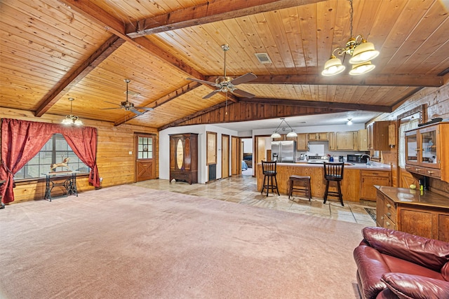 unfurnished living room featuring light colored carpet, ceiling fan with notable chandelier, and wooden ceiling