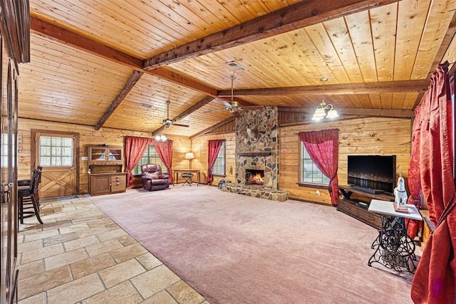 unfurnished living room featuring vaulted ceiling with beams, wooden ceiling, a fireplace, and wood walls