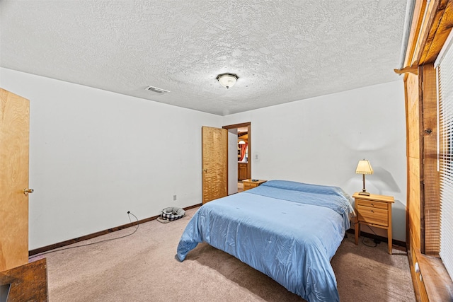 carpeted bedroom with a textured ceiling