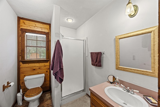 bathroom with vanity, toilet, a textured ceiling, and walk in shower