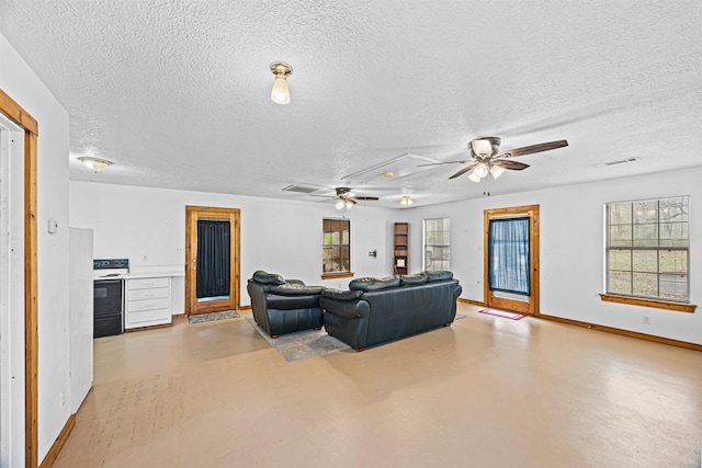 living room with a textured ceiling and ceiling fan