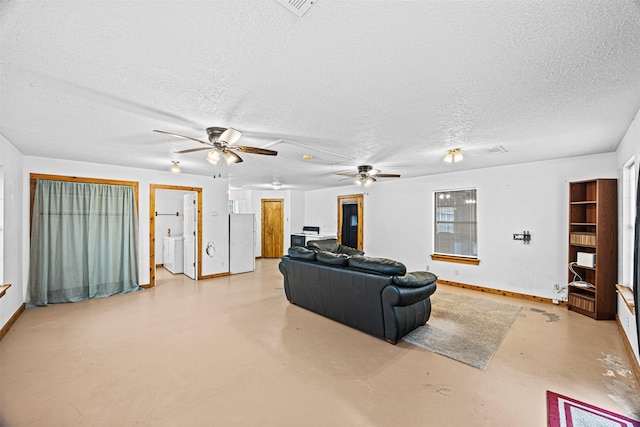 living room featuring ceiling fan and a textured ceiling