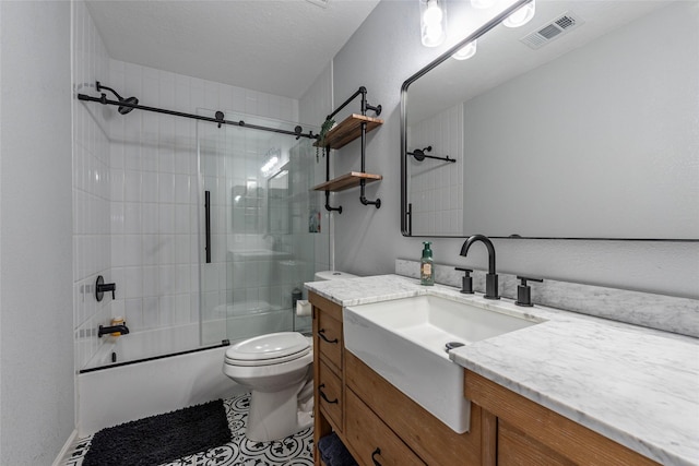 full bathroom with vanity, shower / bath combination with glass door, and toilet