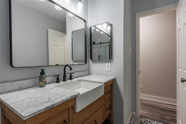 bathroom with vanity and wood-type flooring