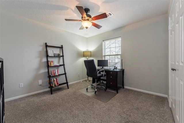 carpeted home office featuring ceiling fan and a textured ceiling