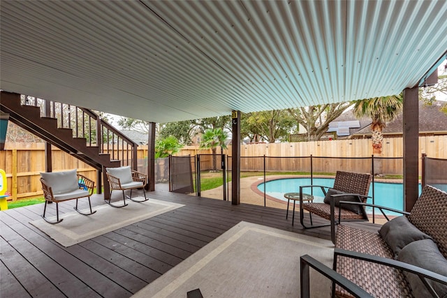 wooden deck featuring a fenced in pool