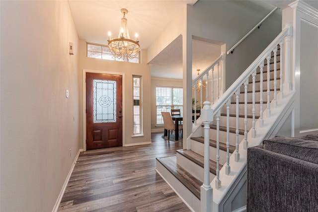 foyer with hardwood / wood-style flooring and a chandelier