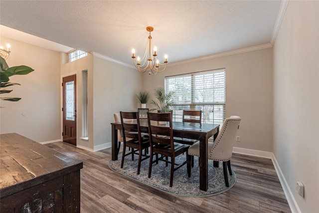 dining space with crown molding, dark wood-type flooring, a textured ceiling, and a chandelier