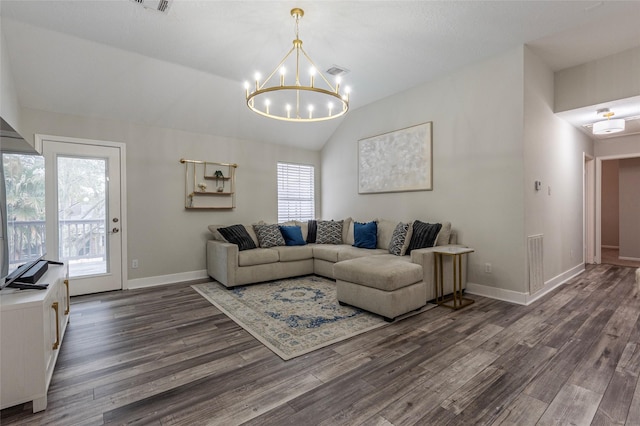 living room featuring lofted ceiling, dark hardwood / wood-style floors, and a healthy amount of sunlight