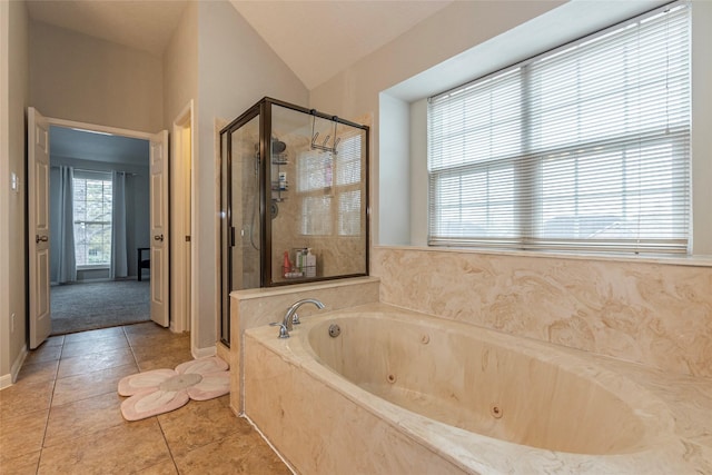 bathroom with tile patterned flooring, shower with separate bathtub, and lofted ceiling