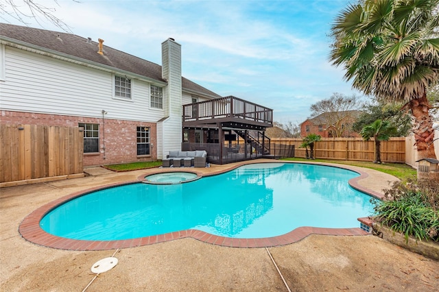 view of swimming pool with an outdoor living space, an in ground hot tub, a deck, and a patio