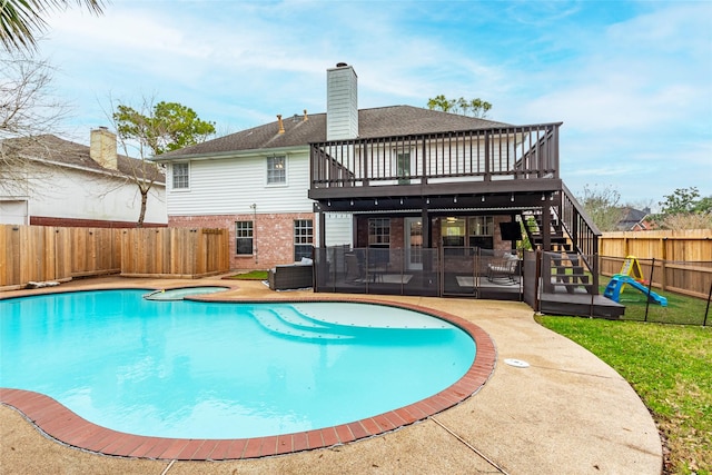 back of property featuring a swimming pool with hot tub and a patio area