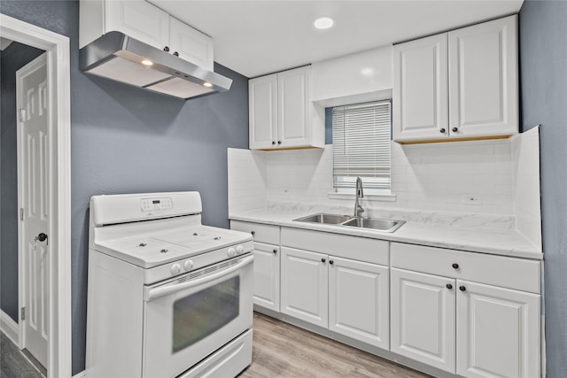 kitchen with white cabinetry, white gas range, sink, decorative backsplash, and light wood-type flooring