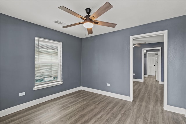 unfurnished room with hardwood / wood-style floors and ceiling fan