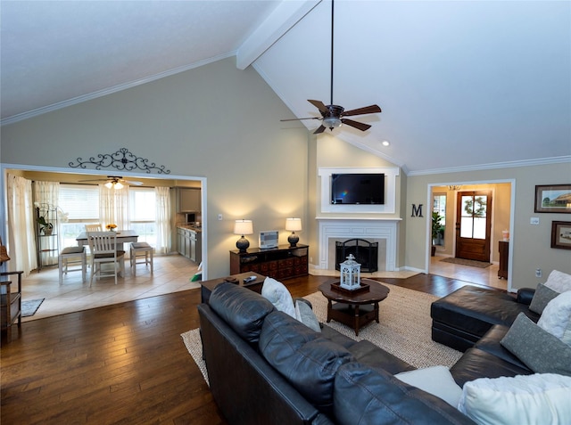 living room with hardwood / wood-style flooring, crown molding, ceiling fan, and beamed ceiling