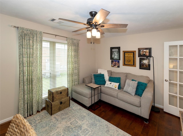 living room with dark wood-type flooring and ceiling fan