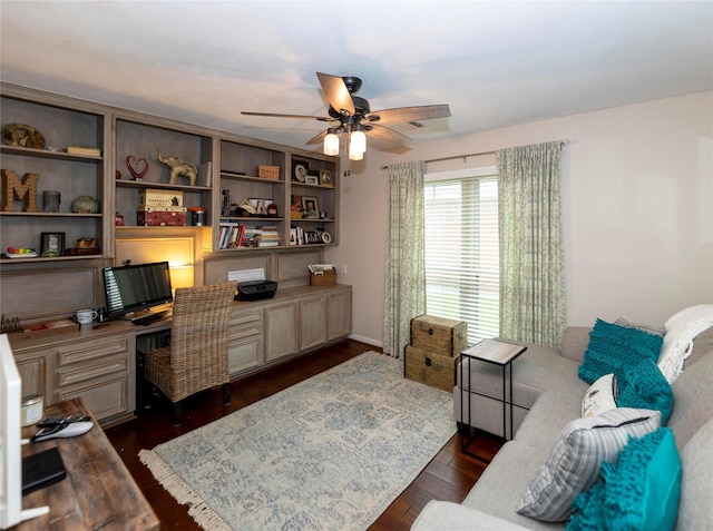 office area with built in desk, dark hardwood / wood-style floors, and ceiling fan