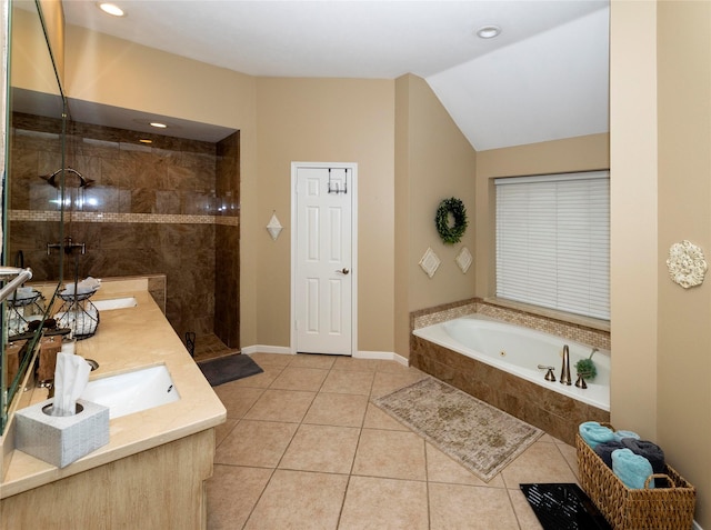 bathroom featuring lofted ceiling, independent shower and bath, tile patterned flooring, and vanity