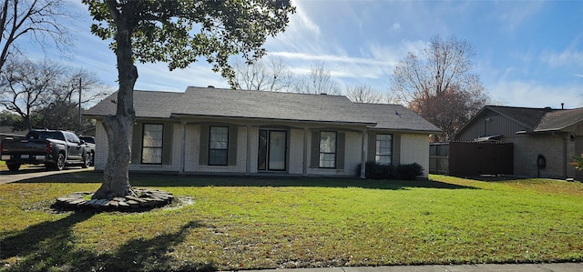 single story home featuring a front yard