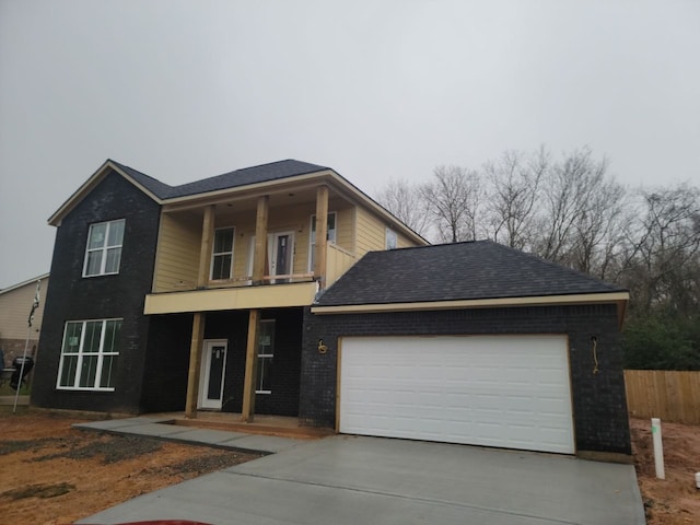 view of front of house with a garage and a balcony