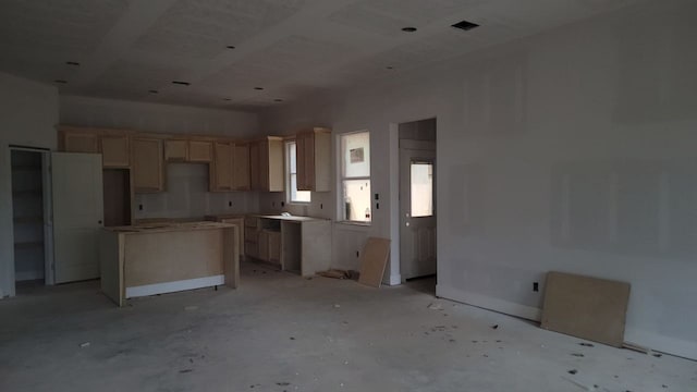 kitchen featuring light brown cabinetry and a center island