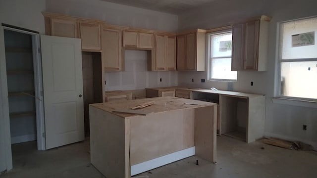 kitchen featuring a kitchen island and light brown cabinets