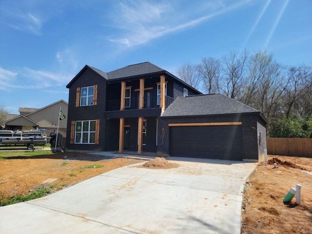 view of front facade featuring driveway, a balcony, fence, a garage, and brick siding