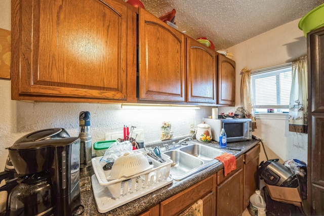 kitchen with sink and a textured ceiling