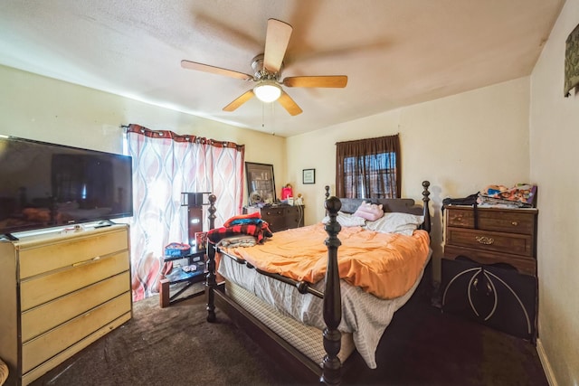 bedroom featuring ceiling fan and dark colored carpet