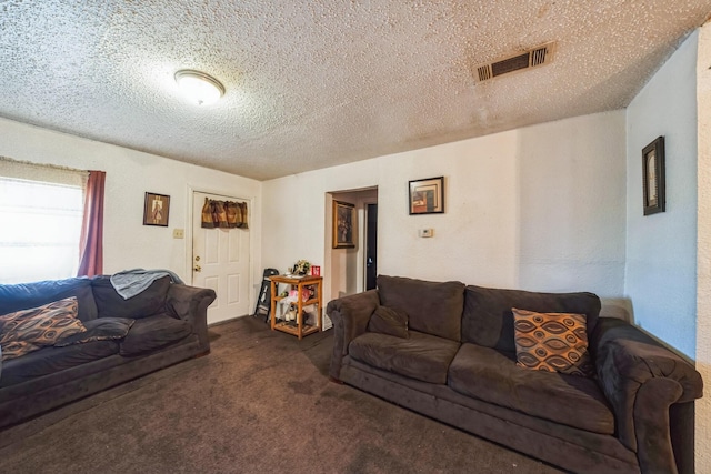 carpeted living room featuring a textured ceiling