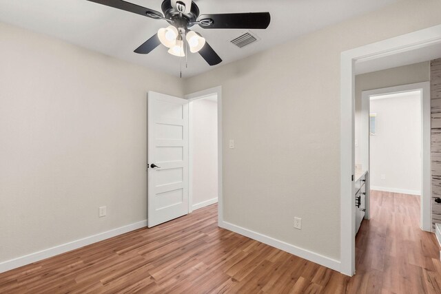 unfurnished bedroom with light hardwood / wood-style floors and ceiling fan