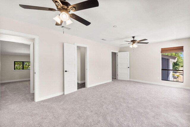 unfurnished bedroom featuring ceiling fan and carpet flooring