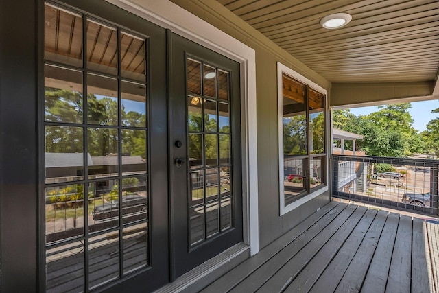 doorway with hardwood / wood-style flooring and wooden ceiling