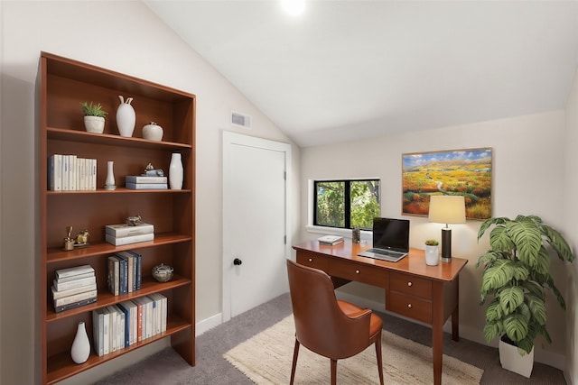 carpeted home office with lofted ceiling