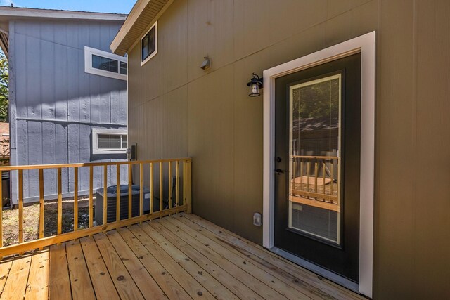 wooden terrace featuring central AC unit